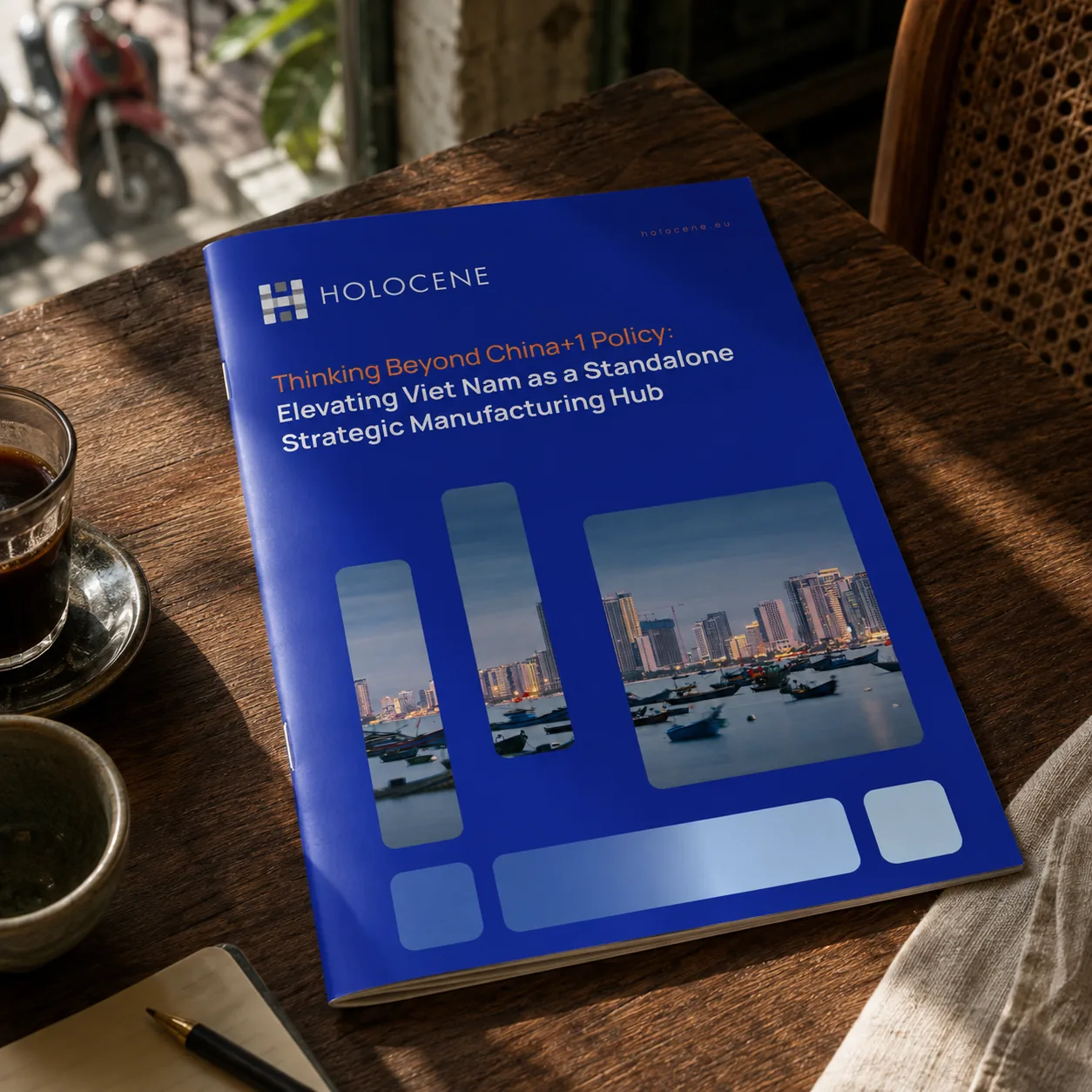 Holocene Thinking Beyond China+1 white paper — printed mockup on a café table